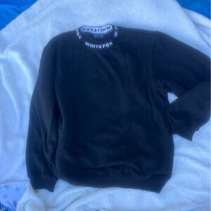 Black women’s sweatshirt with White Fox logo around neck